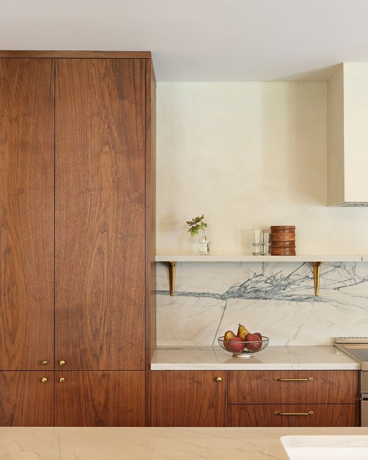 Close-up walnut built-in cabinetry with marble backsplash in Billings Montana.