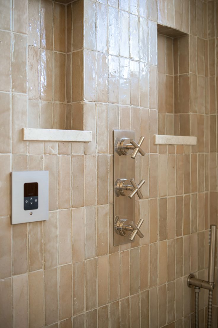 Finished custom tile shower with warm beige tile and brass fixtures in Billings Montana.